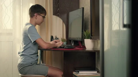 Boy writes program code at home using computer Stock Footage 236638161