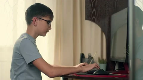Boy writes program code at home using computer Stock Footage 236638548