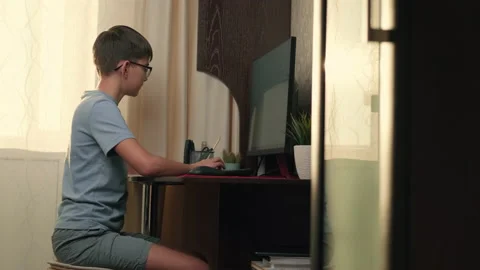 Boy writes program code at home using computer Stock Footage 236640482