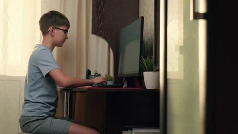 Boy writes program code at home using computer Stock Footage 236640630