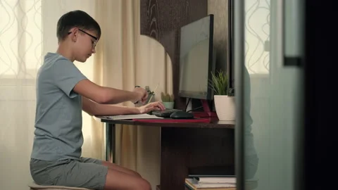 Boy writes program code at home using computer Stock Footage 236640975