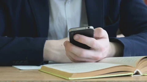 Boy writes the text using a mobile phone indoors Stock Footage 68926418