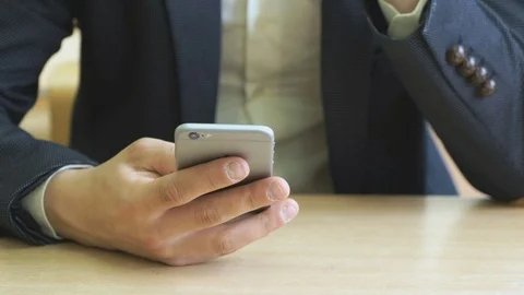 The boy writes the text using a smartphone Stock Footage 71480360