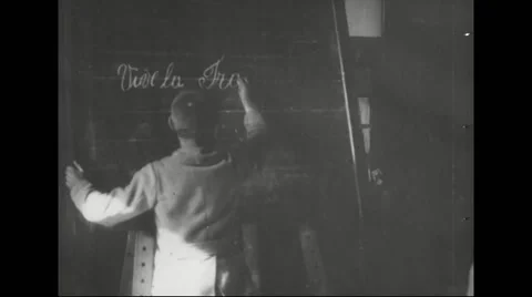 Boy writing on blackboard in classroom Stock Footage