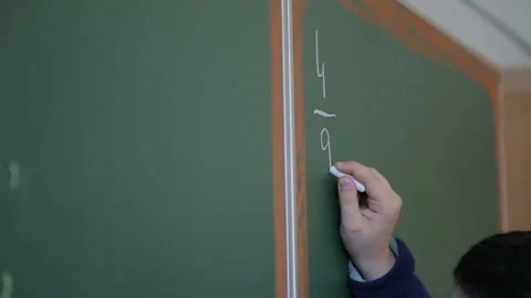 Boy writing on a blackboard in elementary school 1 Stock Footage 268283228