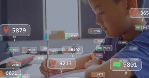 Boy writing glancing up as notification bubble popping, overlays swirling over Video stock 317459698