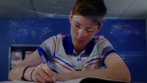 Boy writing in notebook after study cue, pen tracing notes, faint overlay Stock Footage 333078074