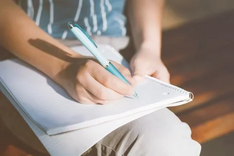 Boy writing in notebook. Stock Photos