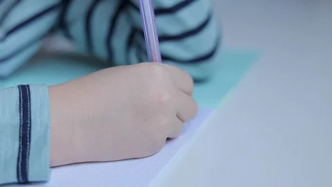 Boy writing with pen on the table Stock Footage 102553301