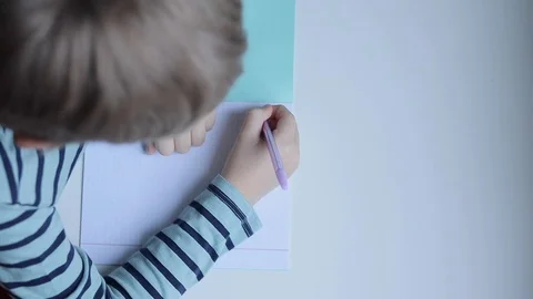 Boy writing with pen on the table Stock Footage 102553320