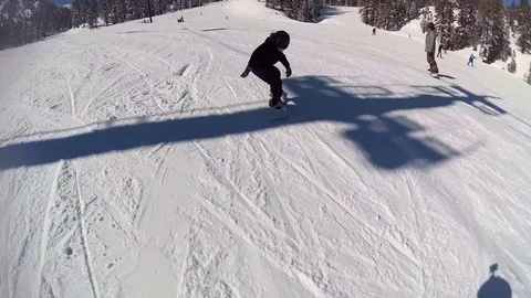A boy youth child snowboarding at a ski resort. Stock Footage