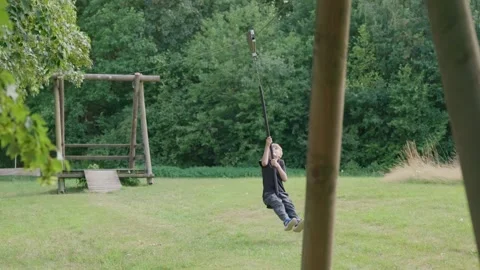 A Boy on a Zip Line Swing Slow Motion Stock Footage 345710842