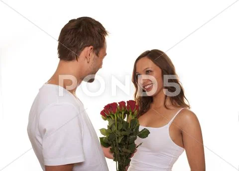Boyfriend giving bunch of flowers to his girlfriend Stock Photos