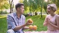 Boyfriend surprising and cheering lady, making tricks and juggling with oranges 4k or 4k+ Resolution