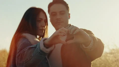 Boyfriends Make Heart With Their Hands at sunset Stock Footage 168529080