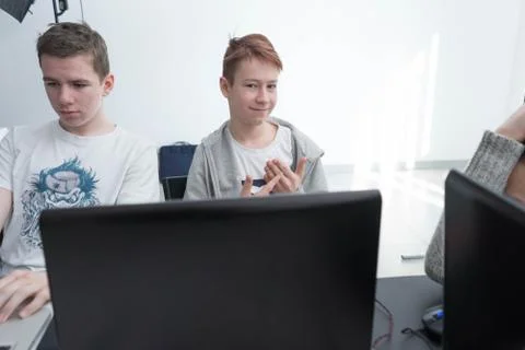 The boys are working with a laptop Stock Photos