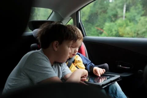 Boys in the car using a touchpad Photos