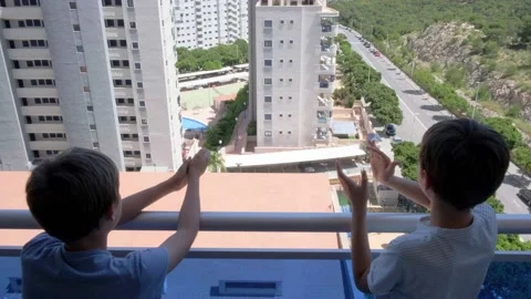 Boys clapping hands, waving hand, greeting with neighbours. Applauding from Stock Footage 131494626