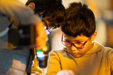 Boys concentrating on a learning and technology activity Stockfoto's