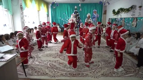 Boys dancing in front of a Christmas tree. Stock Footage 256013503