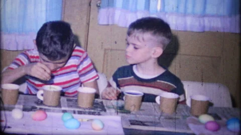Boys dye eggs at home for Easter Egg hunt 1950s family home movie 7318 Stock Footage 234926715