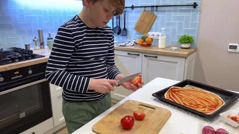 A boys first attempt at pizza-making Stock Footage 302932739