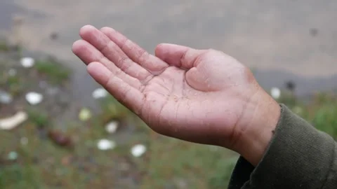 Boys hand playing with falling raindrops Stock-Footage 308394924