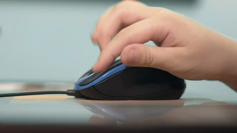 The Boy's Hand Uses A Computer Mouse Close-Up, Playing Game Stock Footage 99047715