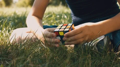 Boy's Hands Collects Rubik's Cube. Smart Child Holding Rubiks Cube Stock Footage 116047053