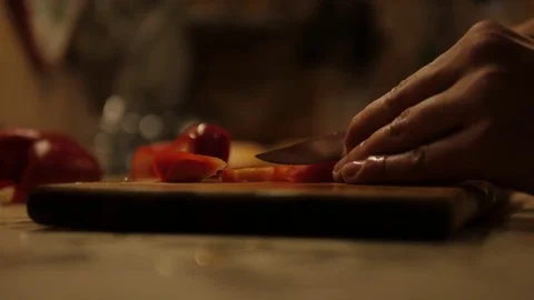 Boy's hands slicing red pepper on chopping board at home 스톡 동영상 80595984