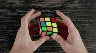Boys Hands Solving Rubik's Cube. Top View Stock Footage