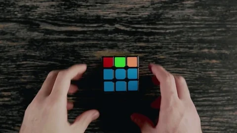Boys hands solving Rubik's Cube. Top view Vídeo Stock 82902028