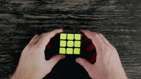 Boys hands solving Rubik's Cube. Top view Video stock 82902659