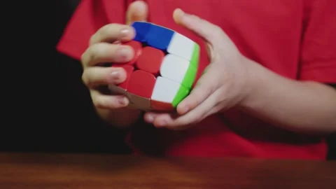 Boy's hands solving rubik's cube puzzle Stock Footage 146739773