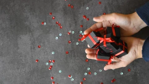 The boy's hands throw gift boxes on the black background. 스톡 동영상 162560302