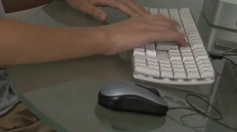 Boy's hands typing on computer keyboard Stock Footage 6498571