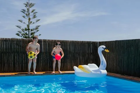 Boys having fun in a pool. Stock Photos