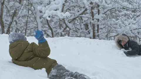 Boys having fun with snow in winter park in vacation Stock Footage 147752086