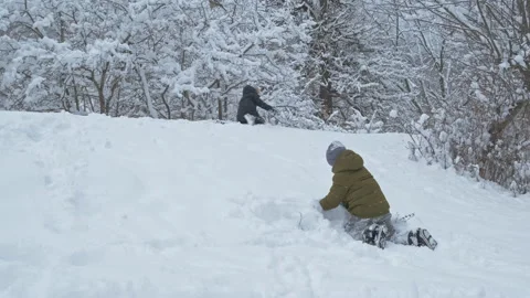 Boys having fun with snow in winter park in vacation Stock Footage 147764392