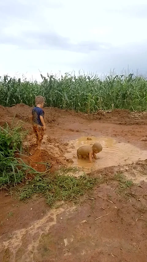 Boys Jump Into Mud Puddle - 08 Jan 2023 Stock Footage 241835795