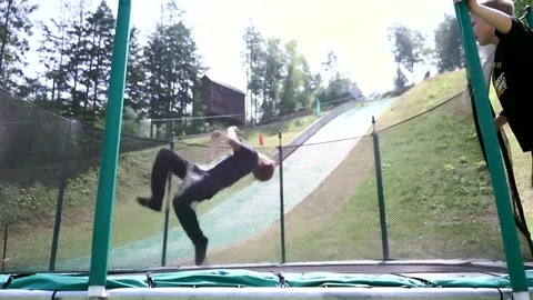 Boys jumping on a trampoline Stock Footage 77799892