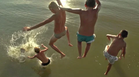 Boys jumping into the water Stock Footage 56564013