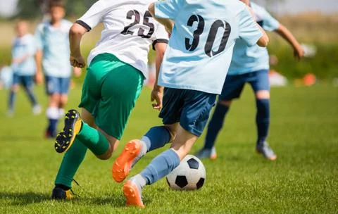 Boys Kicking Soccer Match on Grass. Youth Football Game. Children Sports Stock Photos