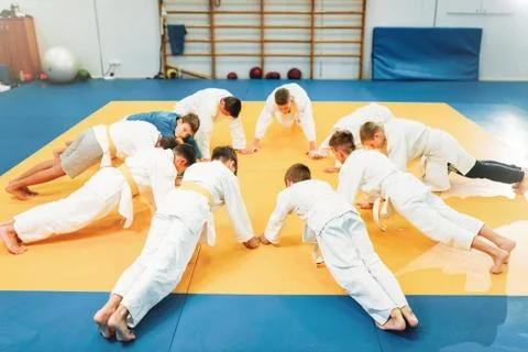 Boys in kimono makes push up exercise, kid judo Stock Photos