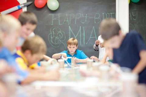 Boys making objects at children's birthday party 写真素材