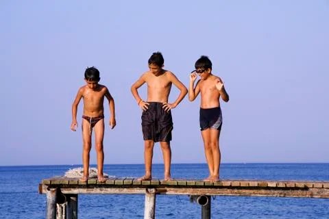 Boys on pier Stock Photos