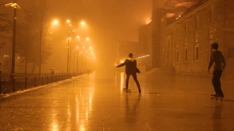 Boys playing and cat walking in mist on the garden of the mosque Stock Footage 102439526