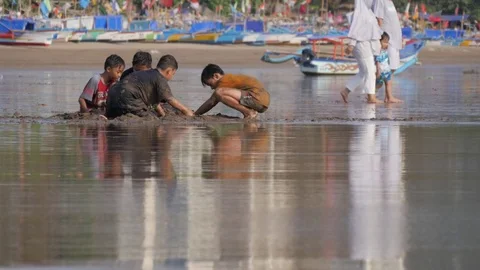 Boys playing on beach in Pangandaran Java Indonesia Stock Footage 84047471