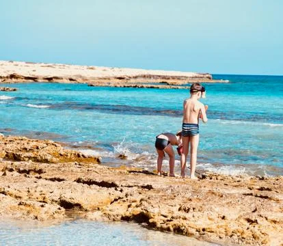 Boys playing on the beach Stock Photos
