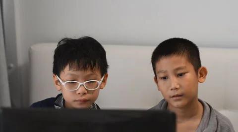 Boys playing game on computer Stock Footage 57331296